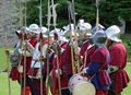 Re-enactors holding examples of Italian and English bills